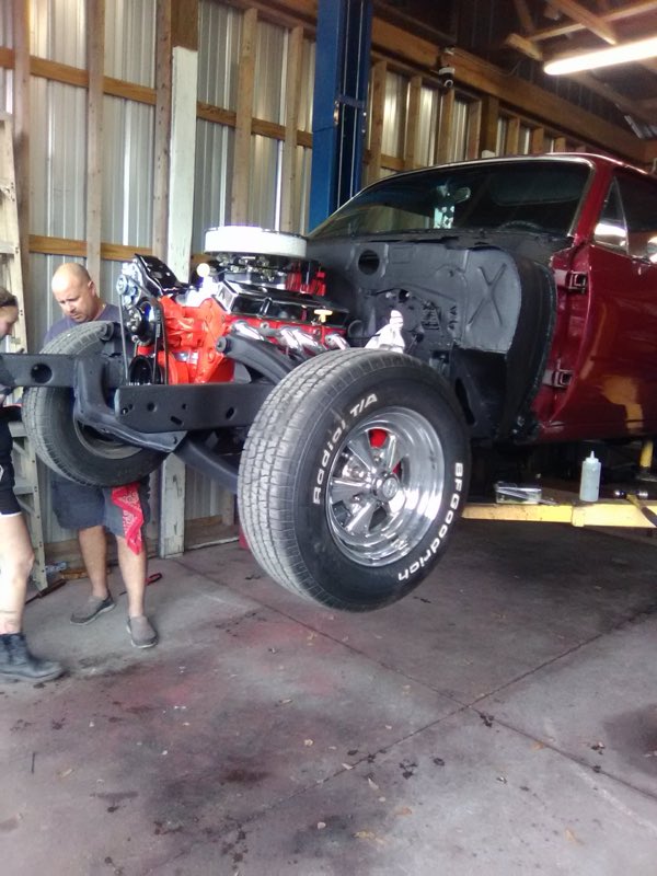 Engine and chassis work under way on a vehicle in the shop bay